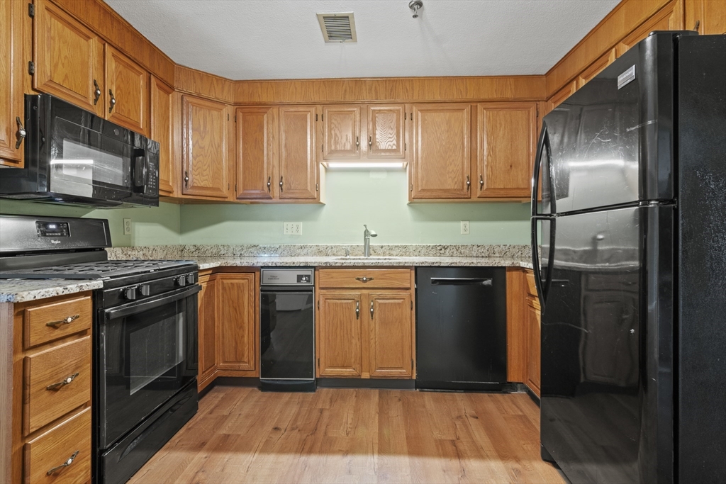 45 Christopher Drive, Unit 101 Methuen, MA 01844 - Photo 10 of 32 a kitchen with granite countertop a refrigerator stove and oven