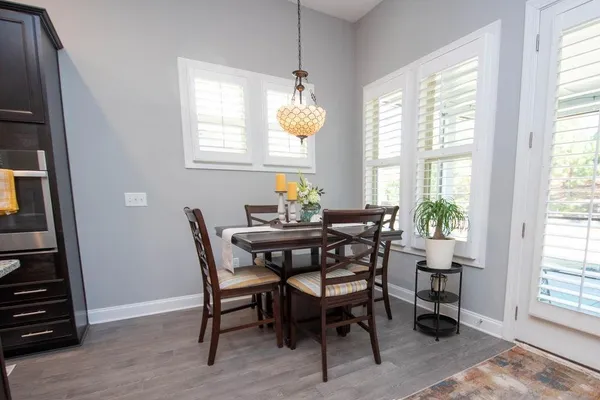 a dining room with furniture a rug and wooden floor
