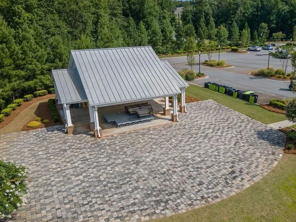 an aerial view of a house with swimming pool and outdoor seating