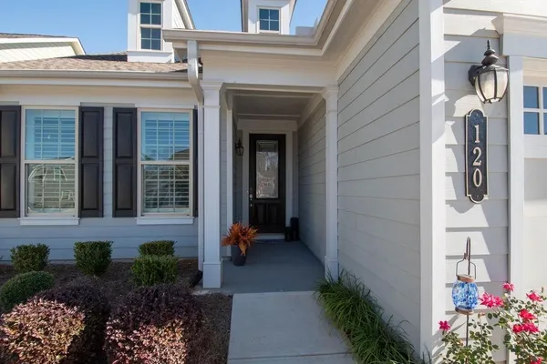 a view of a brick house with potted plants