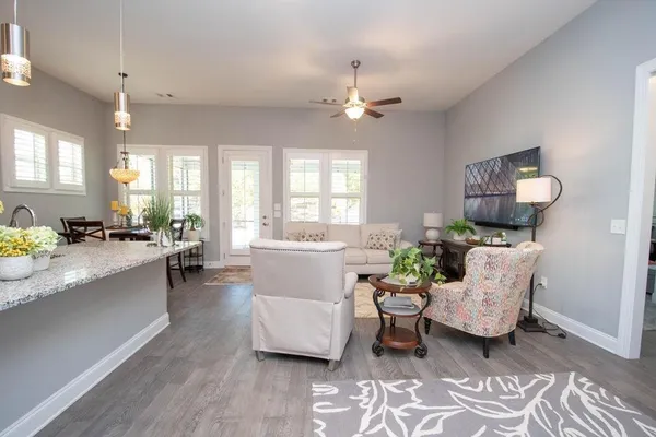 a living room with furniture and a chandelier