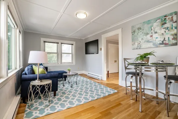 a living room with furniture and wooden floor
