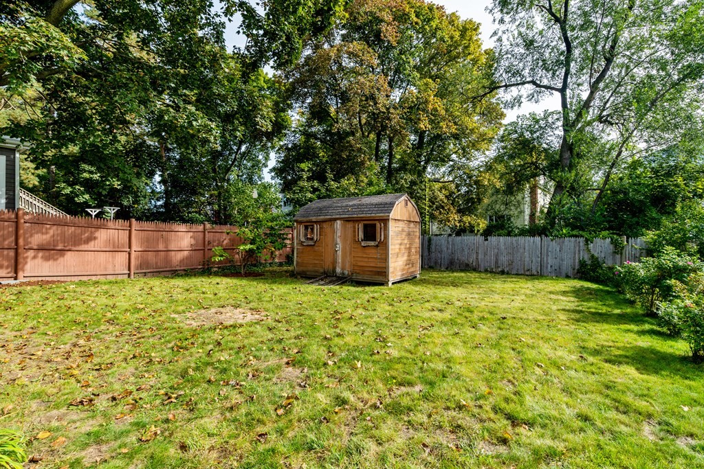 32 Magoun Street, Unit 2 Cambridge, MA 02140 - Photo 12 of 13 a backyard of a house with plants and large trees