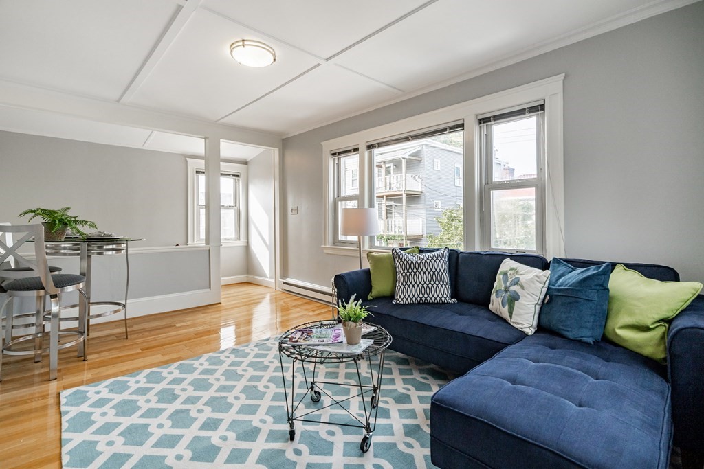 32 Magoun Street, Unit 2 Cambridge, MA 02140 - Photo 2 of 13 a living room with furniture and a large window