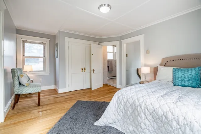 a bedroom with a bed and chair