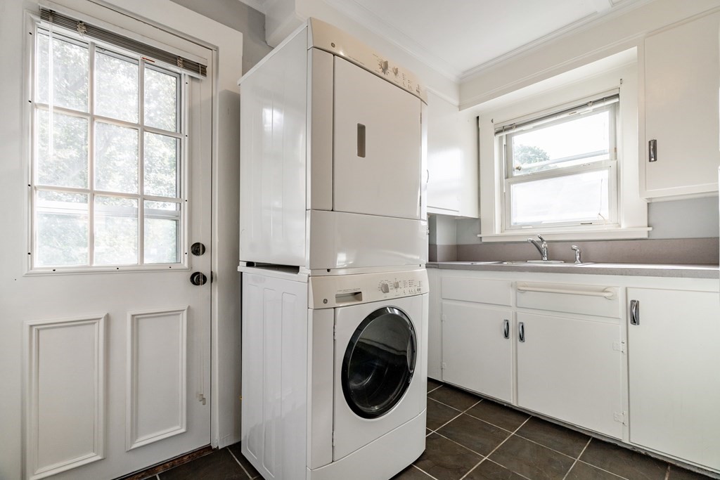 32 Magoun Street, Unit 2 Cambridge, MA 02140 - Photo 7 of 13 a bathroom with a sink a washer and dryer with wooden floor