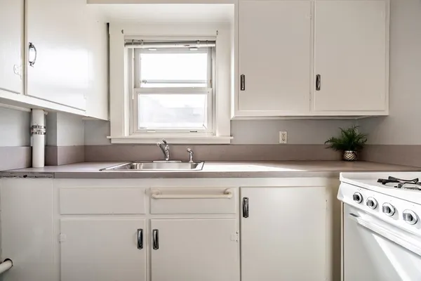 a kitchen with appliances cabinets and a sink