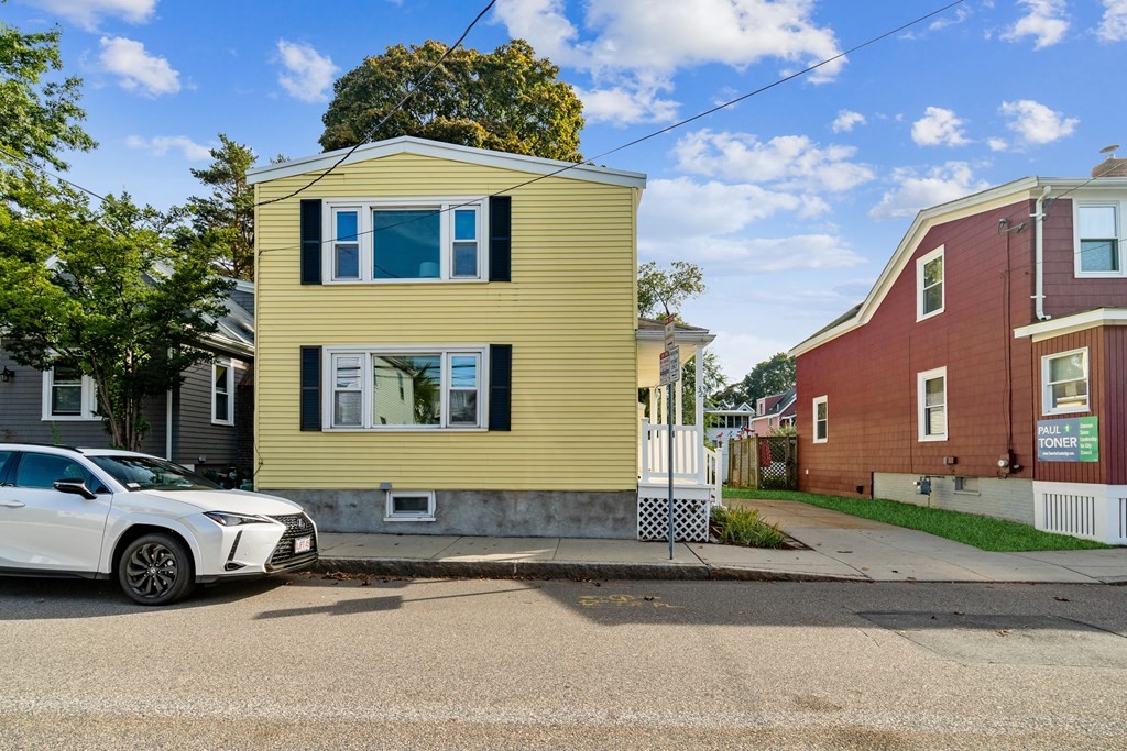 32 Magoun Street, Unit 2 Cambridge, MA 02140 - Photo 10 of 13 a blue and white car parked in front of a house