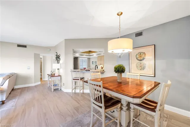 a dining room with furniture and wooden floor