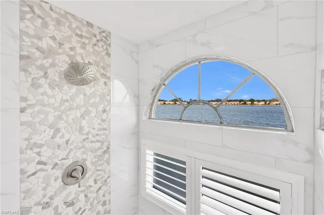 a bedroom with double bed and a window