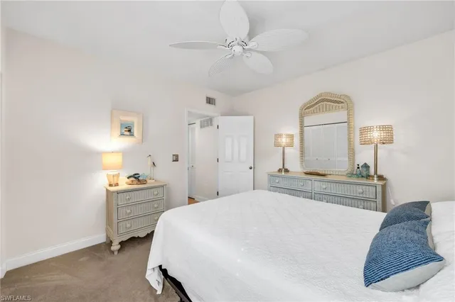 a bathroom with a granite countertop sink a toilet a mirror a vanity a shower and bathtub