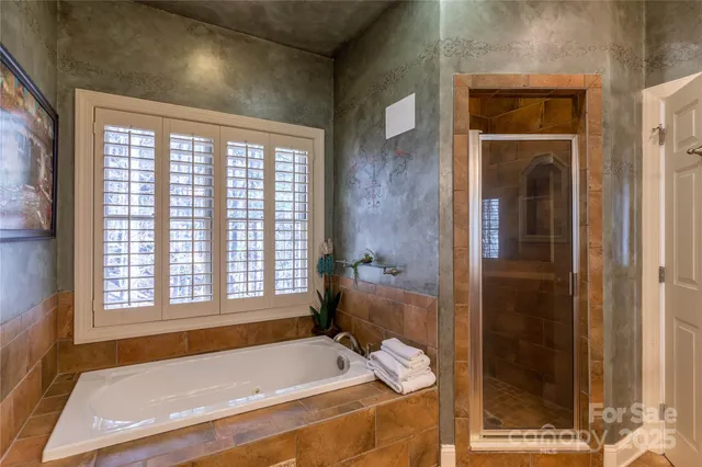 a bedroom with a bed next to a window