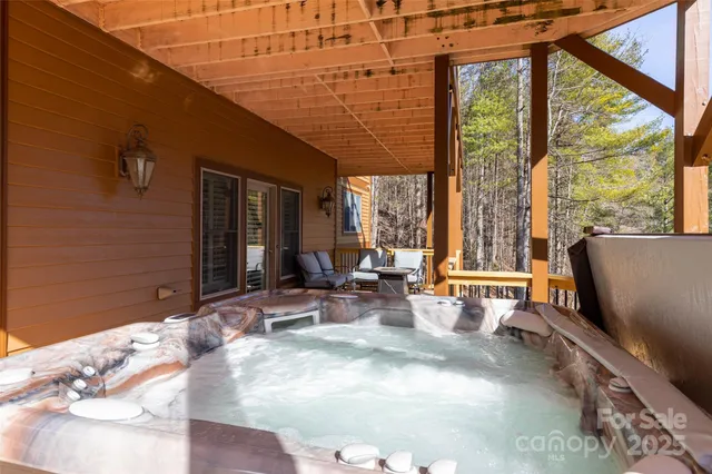 a view of a patio with table and chairs with wooden floor and fence