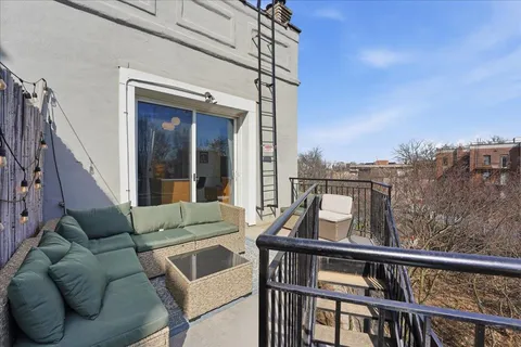 a view of a balcony with furniture