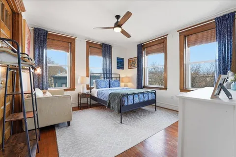 a bedroom with a large bed and a large window