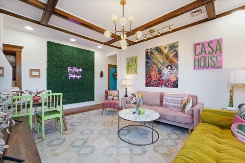 a living room with furniture and a chandelier