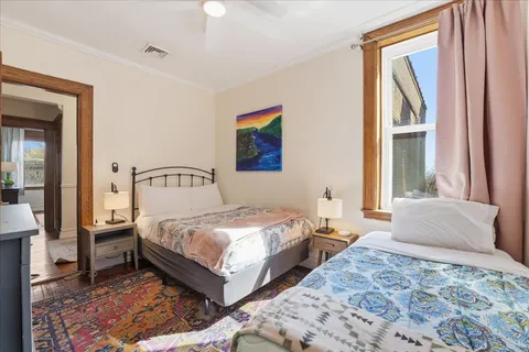 a bedroom with a bed and a window
