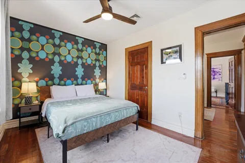 a bedroom with a bed and a painting on the wall