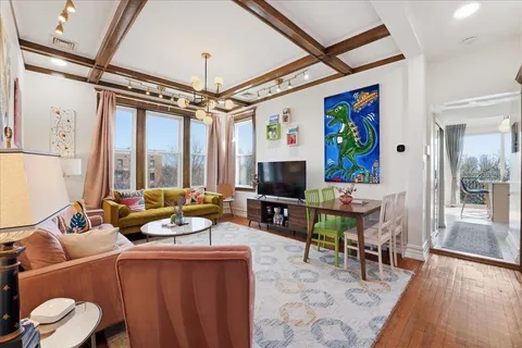 a living room with furniture a flat screen tv and a large window