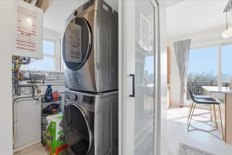 a view of a storage and utility room with washer and dryer