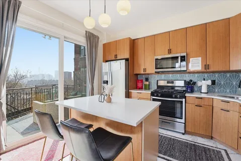 a kitchen with a stove a sink and a refrigerator