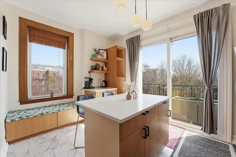a room with a large window and a refrigerator