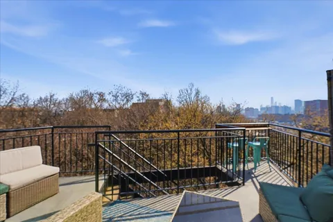 a view of a balcony with wooden floor and city view
