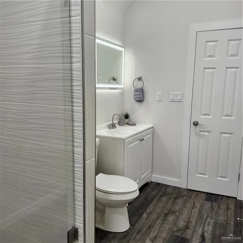 a bathroom with a toilet a sink and mirror