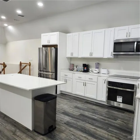 a kitchen with stainless steel appliances a white stove top oven and a refrigerator