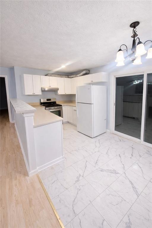 1637 Roman Point Drive Norcross, GA 30093 - Photo 3 of 9 a kitchen with a stove a refrigerator and a sink