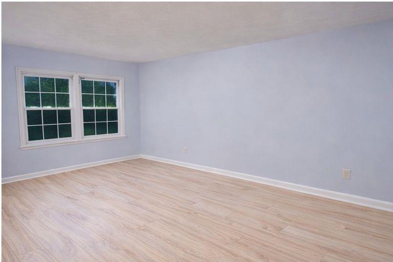 1637 Roman Point Drive Norcross, GA 30093 - Photo 4 of 9 an empty room with wooden floor and windows