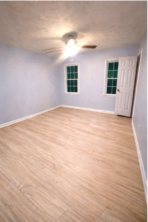 1637 Roman Point Drive Norcross, GA 30093 - Photo 5 of 9 a view of an empty room with wooden floor and a window