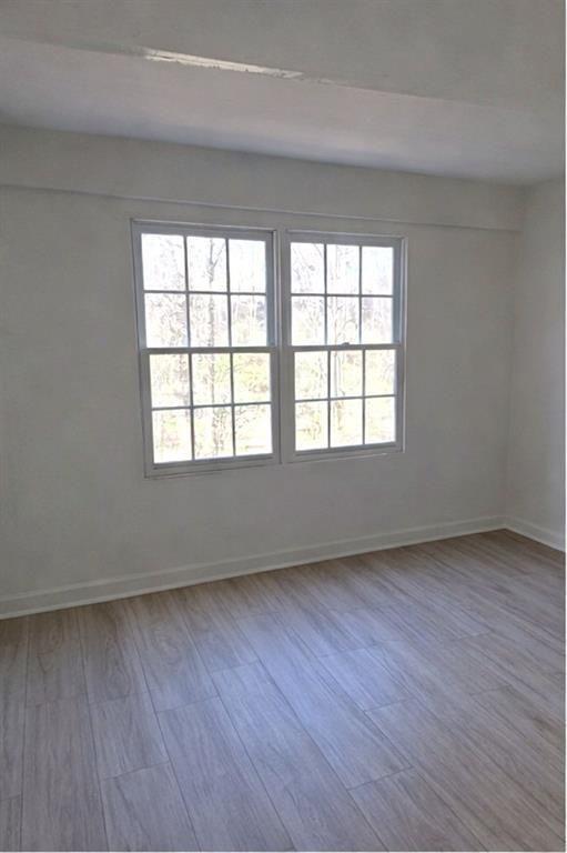 1637 Roman Point Drive Norcross, GA 30093 - Photo 7 of 9 an empty room with wooden floor and windows