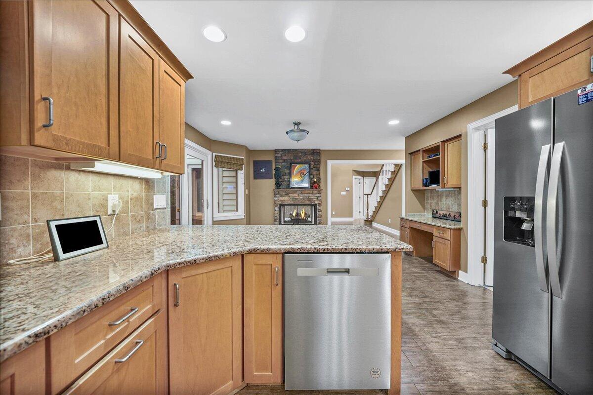 8751 Bridgewater Court Crown Point, IN 46307 - Photo 28 of 49 a kitchen with stainless steel appliances granite countertop a refrigerator a stove and a sink
