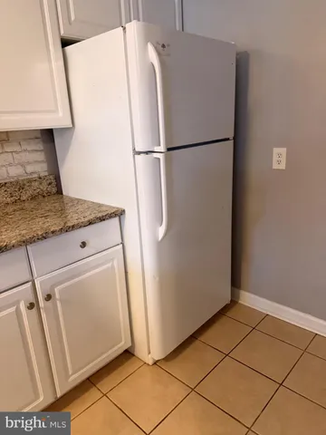 a white refrigerator freezer and a counter in a kitchen