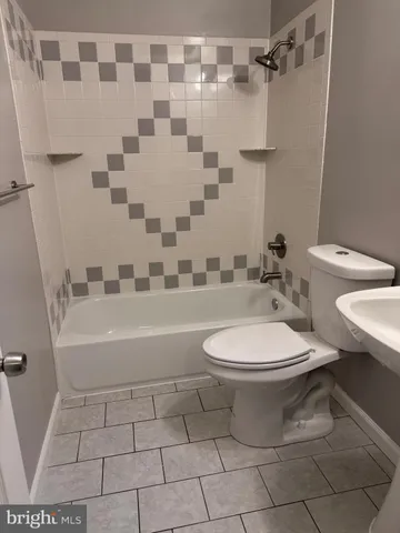 a bathroom with a toilet a sink and a bathtub
