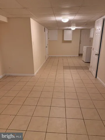 a view of a livingroom with an empty space and a window