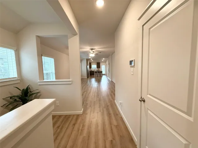 a view of hallway with wooden floor