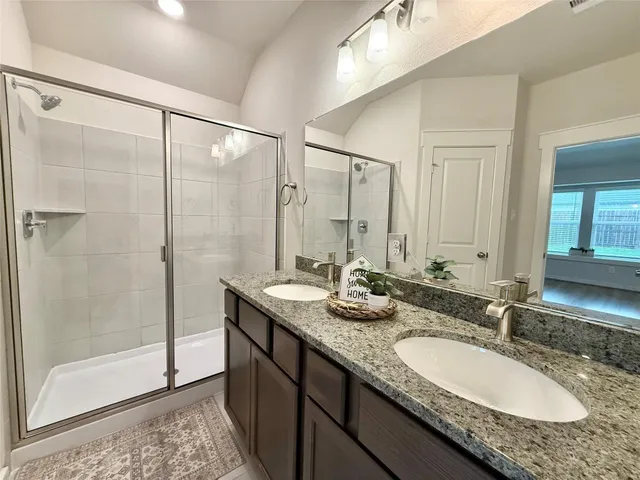 a bathroom with a granite countertop sink mirror and double