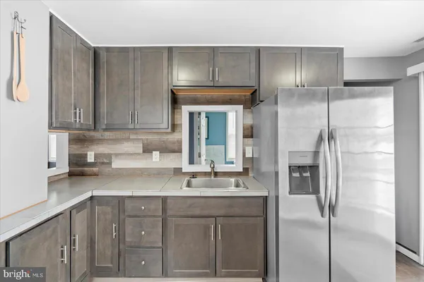 a kitchen with a sink and refrigerator