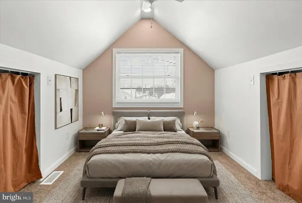 a bedroom with a bed and a window