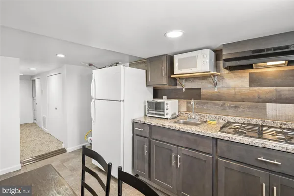 a kitchen with a refrigerator and a sink
