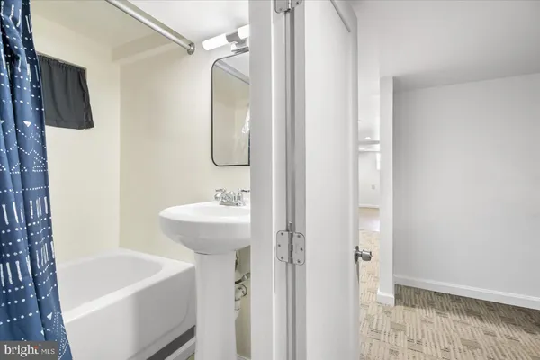 a bathroom with a sink a mirror and a bathtub
