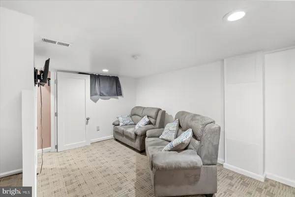 a living room with furniture and a rug