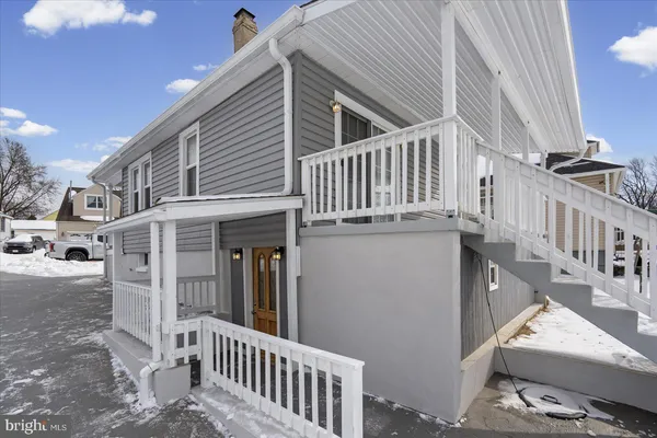 a view of a house with wooden deck