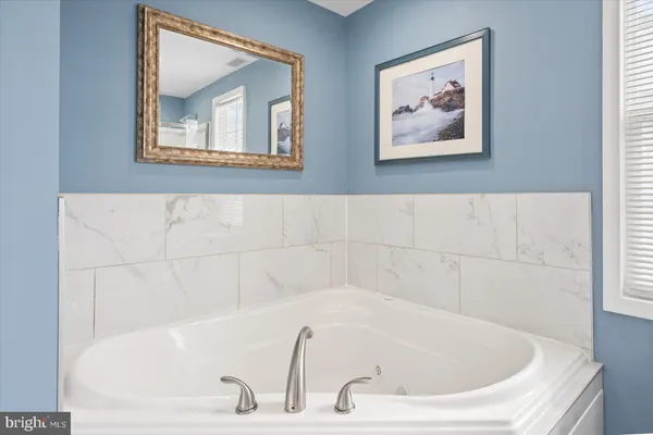 a white bath tub sitting in a bathroom