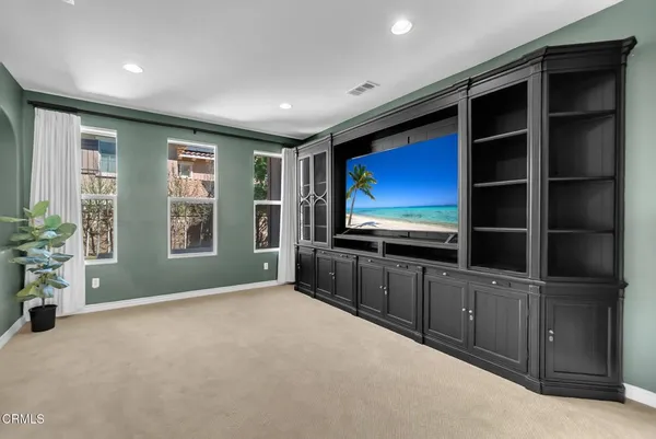 a view of livingroom with furniture flat screen tv and windows