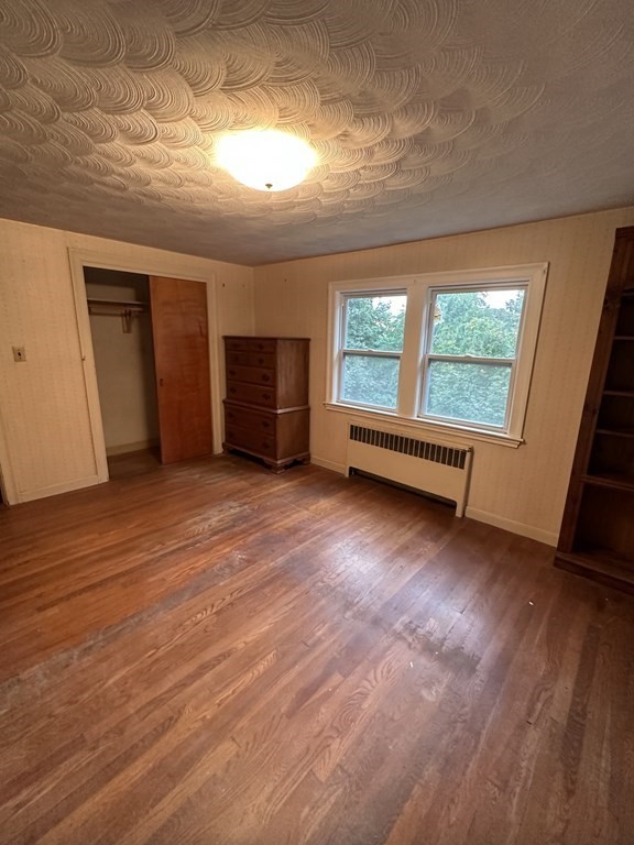 72 Redlands Road Boston, MA 02132 - Photo 11 of 19 an empty room with wooden floor and windows