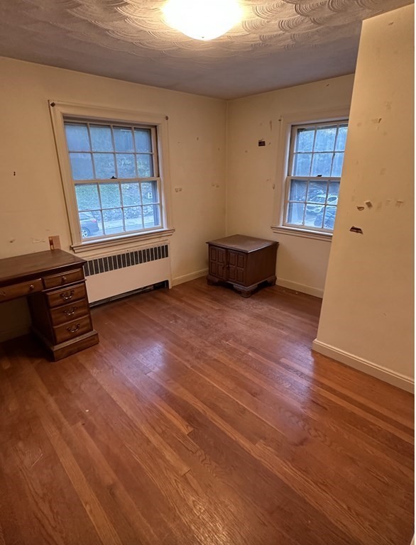 72 Redlands Road Boston, MA 02132 - Photo 15 of 19 an empty room with wooden floor and windows