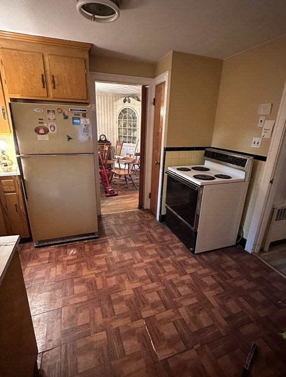 72 Redlands Road Boston, MA 02132 - Photo 6 of 19 a view of a refrigerator in kitchen and utility room